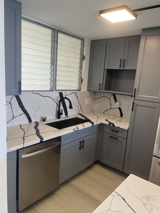 Kitchen with Bold-Vein Quartz Waterfall Island — photo 3